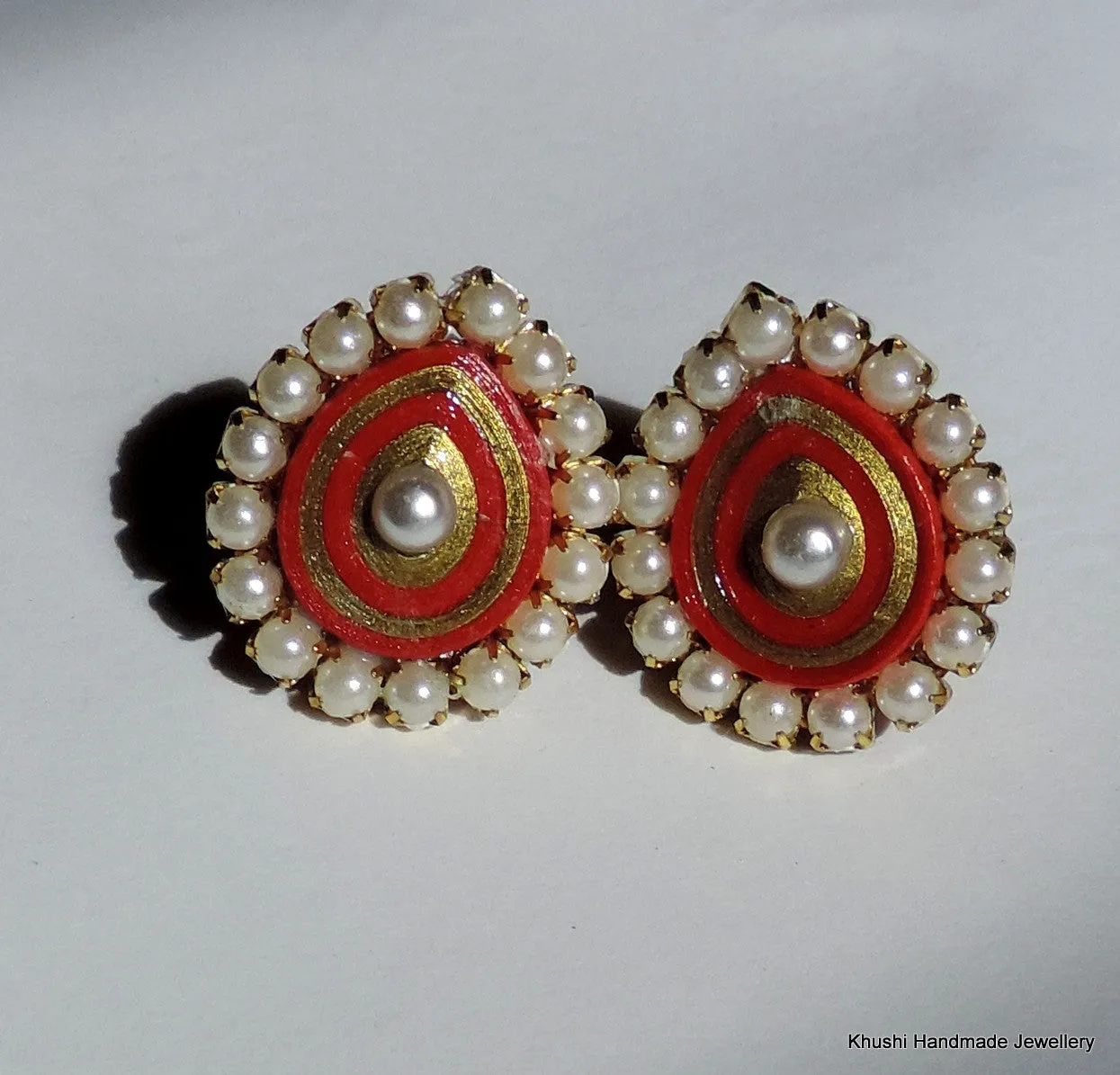 Red studs with pearl lining